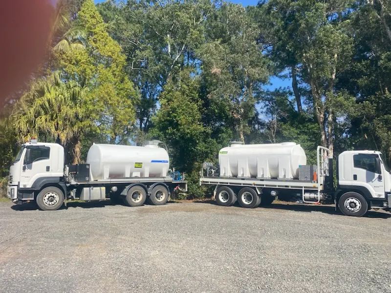 Two Simon Hull water trucks parked side by side in the yard, ready for peak-demand jobs